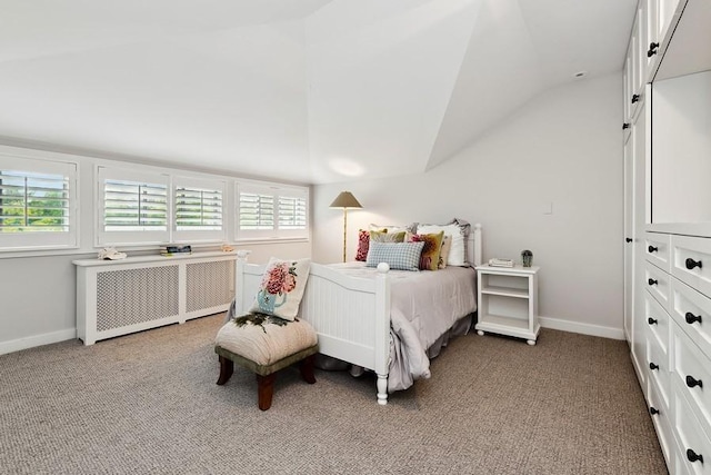 bedroom featuring lofted ceiling, light carpet, multiple windows, and radiator
