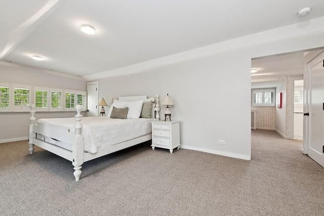 carpeted bedroom featuring baseboards
