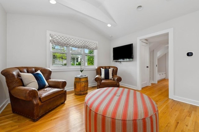 sitting room featuring lofted ceiling and light wood-style floors