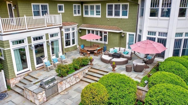 patio / terrace featuring exterior kitchen, outdoor lounge area, and a patio area