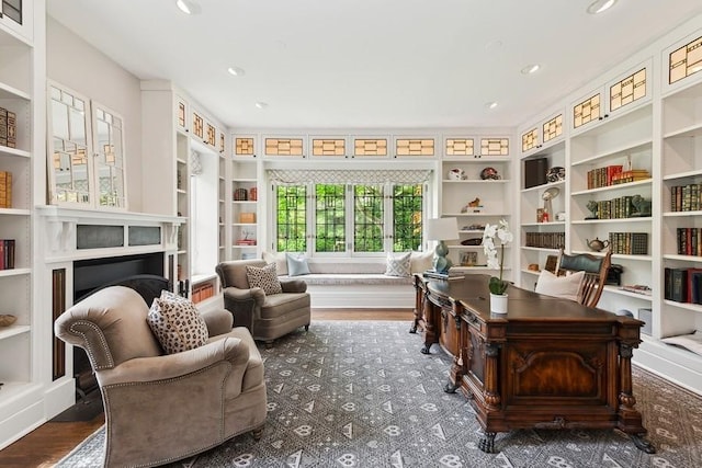 home office with wood finished floors, built in features, and recessed lighting