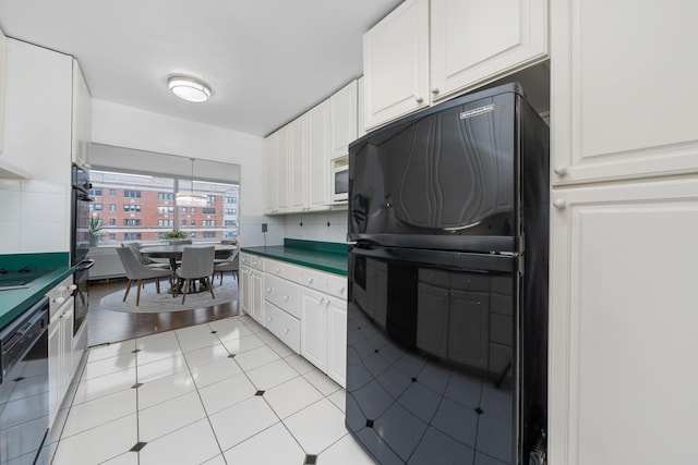 4250 N Marine Dr Unit 1622, Chicago, IL 60613 - kitchen featuring black appliances, white cabinets, backsplash, and dark countertops