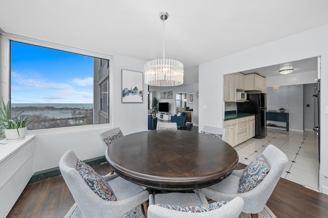 4250 N Marine Dr Unit 1622, Chicago, IL 60613 - dining space featuring a chandelier, light wood-type flooring, and baseboards