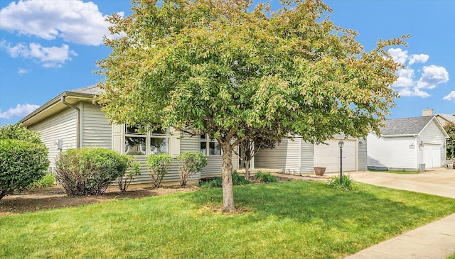 2302 Slade Ln, Mahomet, IL 61853 - view of property hidden behind natural elements featuring concrete driveway, a front yard, and a garage