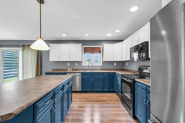 2302 Slade Ln, Mahomet, IL 61853 - kitchen with blue cabinets, black appliances, white cabinetry, hanging light fixtures, and recessed lighting