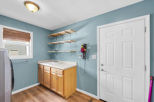 2302 Slade Ln, Mahomet, IL 61853 - laundry room with light wood-style flooring and cabinet space