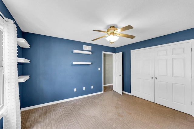 2302 Slade Ln, Mahomet, IL 61853 - unfurnished bedroom with carpet flooring, a closet, and ceiling fan