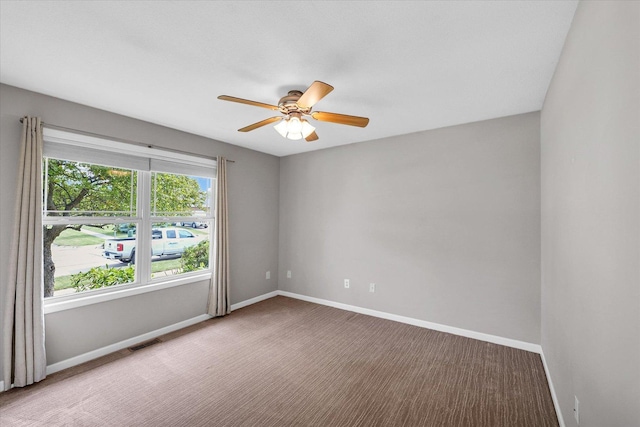 2302 Slade Ln, Mahomet, IL 61853 - carpeted spare room with baseboards and a ceiling fan