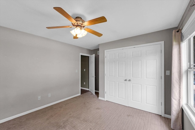 2302 Slade Ln, Mahomet, IL 61853 - unfurnished bedroom with a closet, light colored carpet, and ceiling fan
