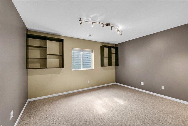 2302 Slade Ln, Mahomet, IL 61853 - carpeted empty room with baseboards and rail lighting