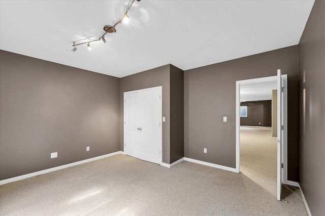 2302 Slade Ln, Mahomet, IL 61853 - unfurnished bedroom with rail lighting and light carpet