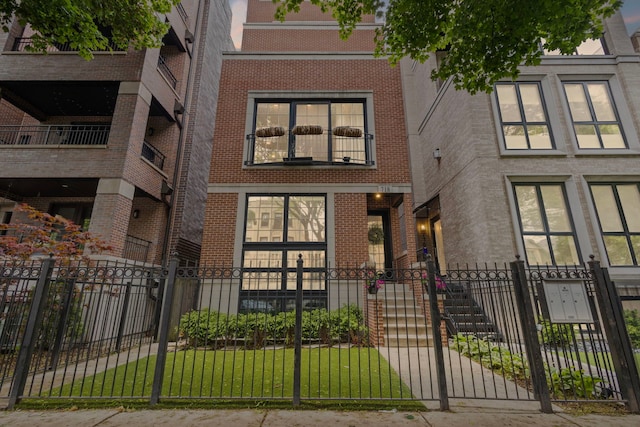 718 W Aldine Ave Unit 3, Chicago, IL 60657 - townhome / multi-family property with brick siding, a fenced front yard, and a gate