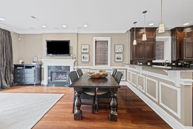 718 W Aldine Ave Unit 3, Chicago, IL 60657 - dining room with a high end fireplace, dark wood-style flooring, ornamental molding, recessed lighting, and wainscoting