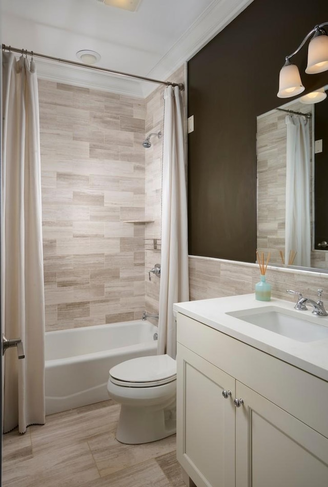 1827 N Larrabee St Unit 4, Chicago, IL 60614 - bathroom with vanity, shower / bath combo with shower curtain, toilet, tile walls, and crown molding