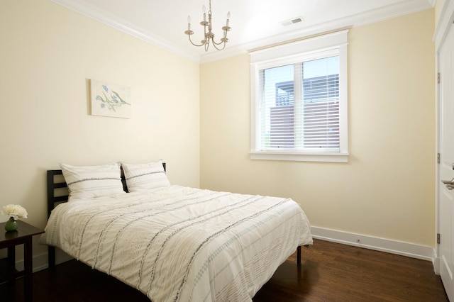 1827 N Larrabee St Unit 4, Chicago, IL 60614 - bedroom with crown molding, dark wood-style flooring, baseboards, and a chandelier