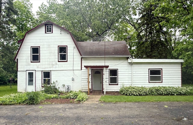 12445 W Pacific Ave, Waukegan, IL 60085 - view of front of home featuring a gambrel roof, view of scattered trees, and roof with shingles