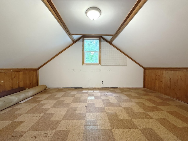 12445 W Pacific Ave, Waukegan, IL 60085 - additional living space with wood walls, vaulted ceiling, and light carpet
