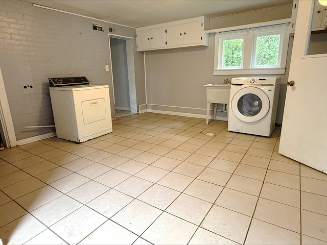 12445 W Pacific Ave, Waukegan, IL 60085 - washroom featuring washer / clothes dryer, cabinet space, and light tile patterned flooring