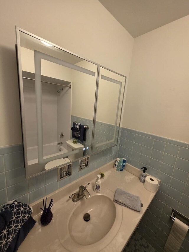 6124 W Berteau Ave, Chicago, IL 60634 - full bathroom featuring bathing tub / shower combination, vanity, and tile walls