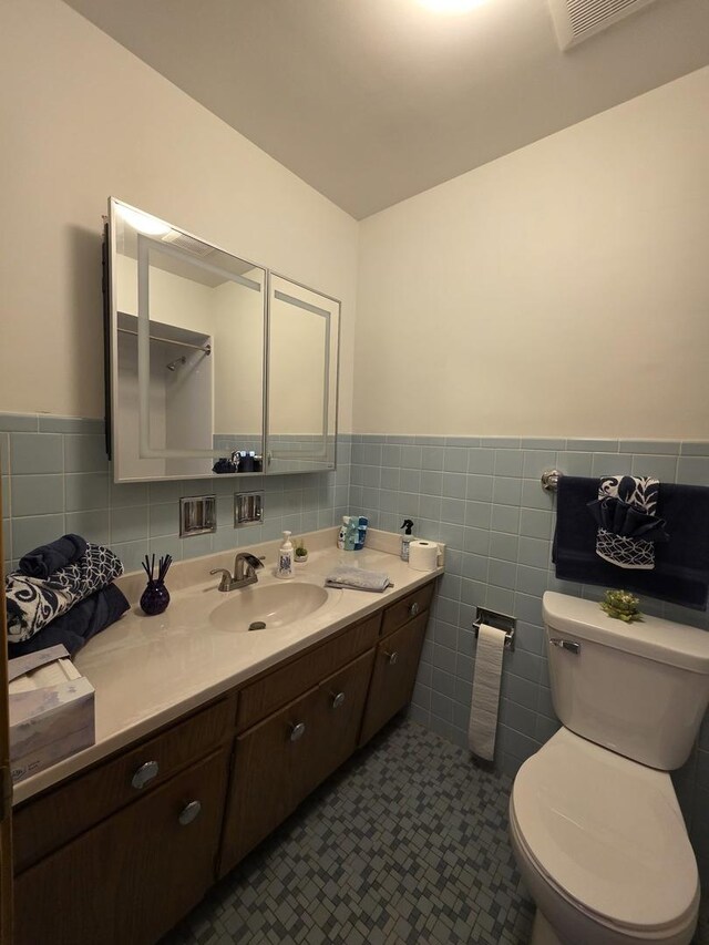 6124 W Berteau Ave, Chicago, IL 60634 - bathroom featuring tile walls, vanity, a wainscoted wall, and toilet