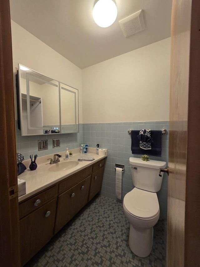 6124 W Berteau Ave, Chicago, IL 60634 - bathroom featuring vanity, wainscoting, toilet, and tile walls