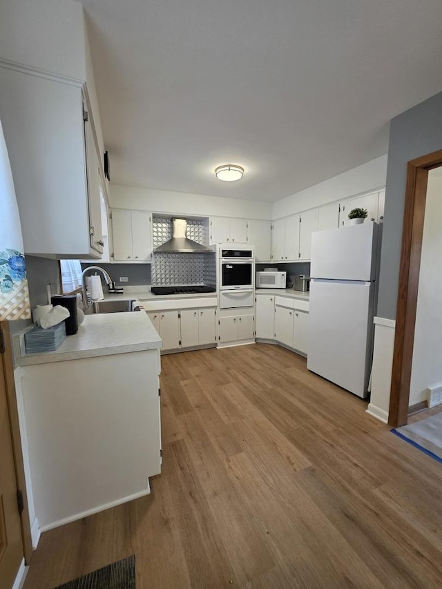 6124 W Berteau Ave, Chicago, IL 60634 - kitchen featuring white appliances, a sink, a warming drawer, light wood finished floors, and light countertops