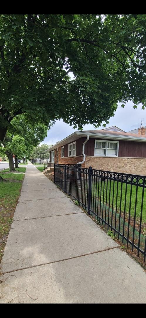 6124 W Berteau Ave, Chicago, IL 60634 - single story home with a fenced front yard and brick siding