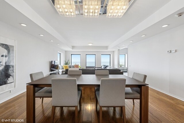 1100 N Lake Shore Dr Unit 33A, Chicago, IL 60611 - dining space with a raised ceiling, wood-type flooring, a chandelier, baseboards, and recessed lighting