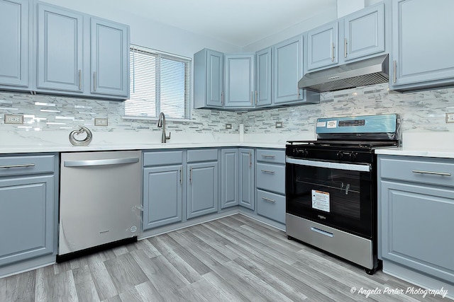 1802 11, Waukegan, IL 60085 - kitchen featuring appliances with stainless steel finishes, under cabinet range hood, gray cabinetry, and a sink