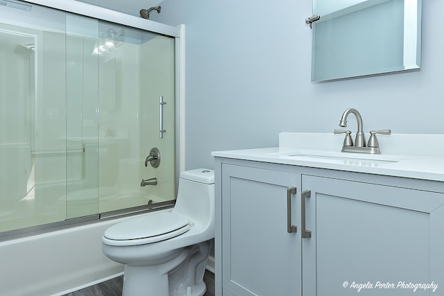 1802 11, Waukegan, IL 60085 - bathroom featuring vanity, toilet, enclosed tub / shower combo, and wood finished floors