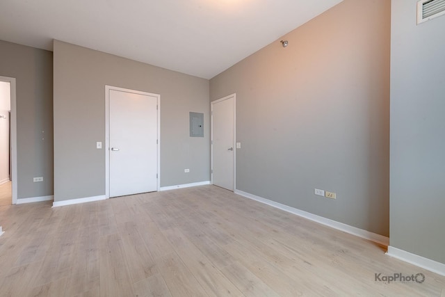757 N Orleans St Unit 1104, Chicago, IL 60654 - unfurnished bedroom featuring light wood-style flooring, baseboards, and electric panel