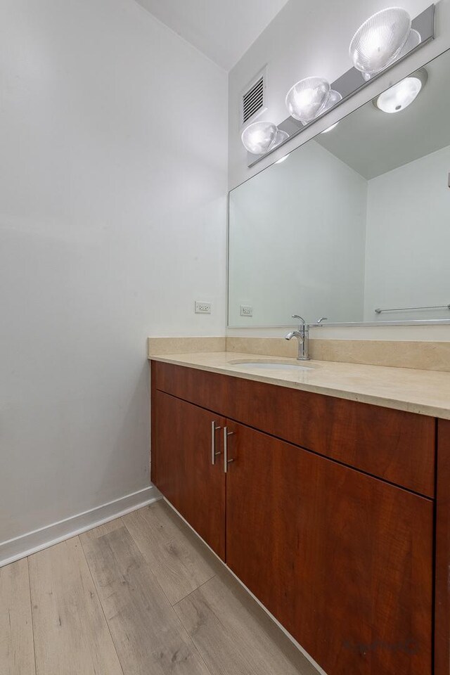 757 N Orleans St Unit 1104, Chicago, IL 60654 - bathroom with vanity, wood finished floors, and baseboards