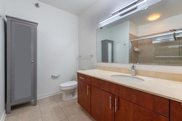 757 N Orleans St Unit 1104, Chicago, IL 60654 - bathroom with vanity, toilet, a stall shower, tile patterned floors, and baseboards