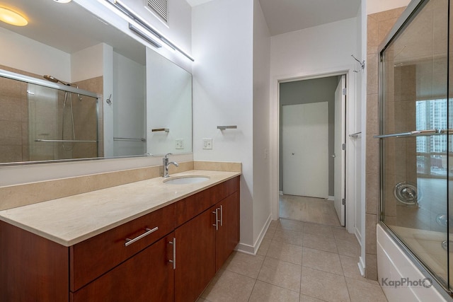 757 N Orleans St Unit 1104, Chicago, IL 60654 - bathroom with vanity, tile patterned flooring, bath / shower combo with glass door, and baseboards