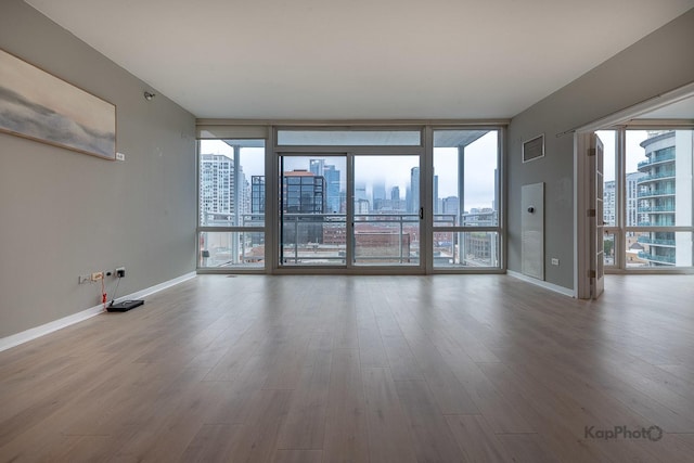 757 N Orleans St Unit 1104, Chicago, IL 60654 - unfurnished room with a city view, wood finished floors, healthy amount of natural light, and floor to ceiling windows