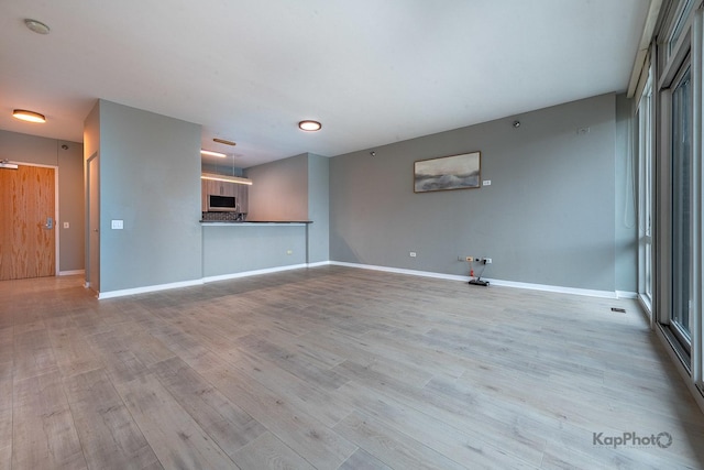 757 N Orleans St Unit 1104, Chicago, IL 60654 - unfurnished living room with wood finished floors and baseboards