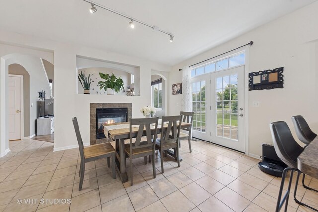 25338 Scott Dr, Plainfield, IL 60544 - dining room with light tile patterned floors, a fireplace, and track lighting