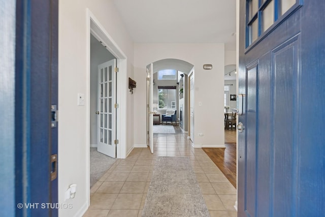 25338 Scott Dr, Plainfield, IL 60544 - entryway featuring arched walkways, light tile patterned flooring, and baseboards