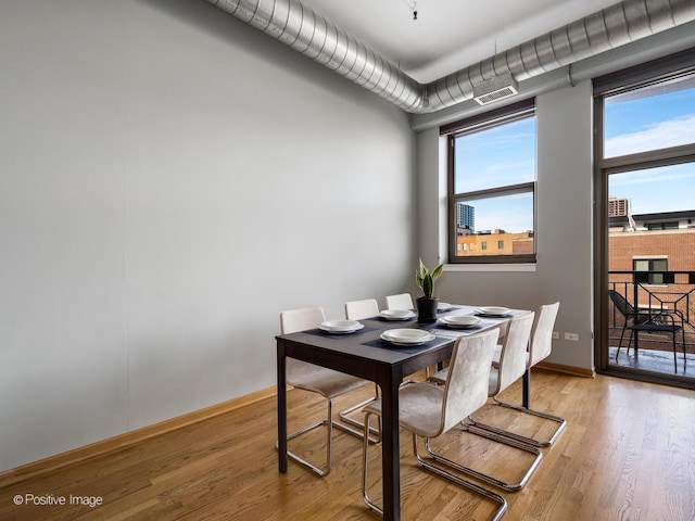 1301 W Madison St Unit 402, Chicago, IL 60607 - dining space with light wood-type flooring and baseboards