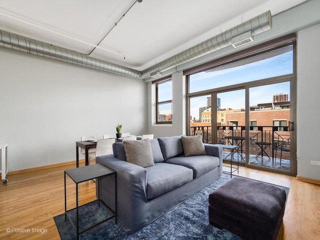 1301 W Madison St Unit 402, Chicago, IL 60607 - living room with wood finished floors and baseboards