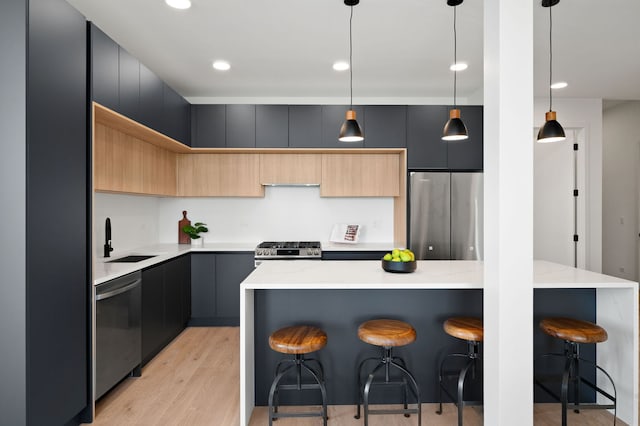 2354 W Farragut Ave Unit Ph-404, Chicago, IL 60625 - kitchen with stainless steel appliances, a sink, modern cabinets, a kitchen breakfast bar, and light wood finished floors