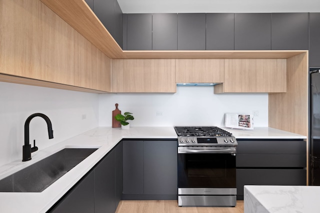 2354 W Farragut Ave Unit Ph-404, Chicago, IL 60625 - kitchen with stainless steel gas stove, modern cabinets, a sink, and light brown cabinetry