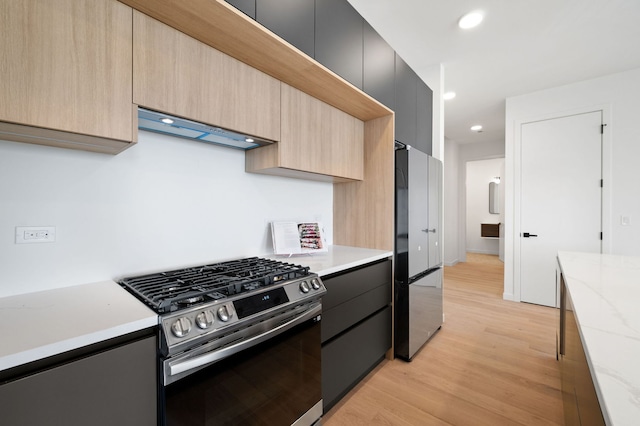 2354 W Farragut Ave Unit Ph-404, Chicago, IL 60625 - kitchen featuring stainless steel gas stove, freestanding refrigerator, ventilation hood, light brown cabinets, and recessed lighting