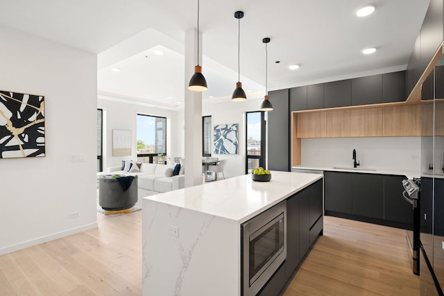 2354 W Farragut Ave Unit Ph-404, Chicago, IL 60625 - kitchen featuring stainless steel microwave, a sink, modern cabinets, light wood-type flooring, and recessed lighting