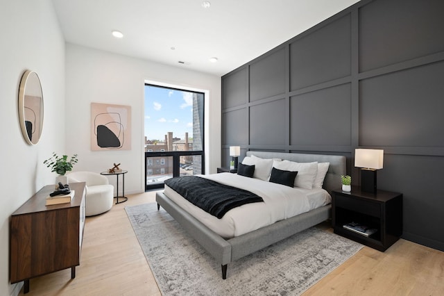 2354 W Farragut Ave Unit Ph-404, Chicago, IL 60625 - bedroom with a decorative wall, light wood-type flooring, a view of city, and recessed lighting