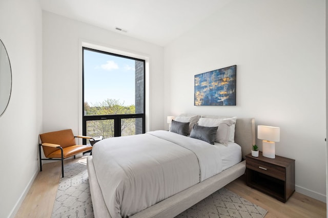 2354 W Farragut Ave Unit Ph-404, Chicago, IL 60625 - bedroom with baseboards and light wood finished floors