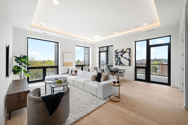 2354 W Farragut Ave Unit Ph-404, Chicago, IL 60625 - living room featuring a raised ceiling, light wood-style flooring, baseboards, and recessed lighting