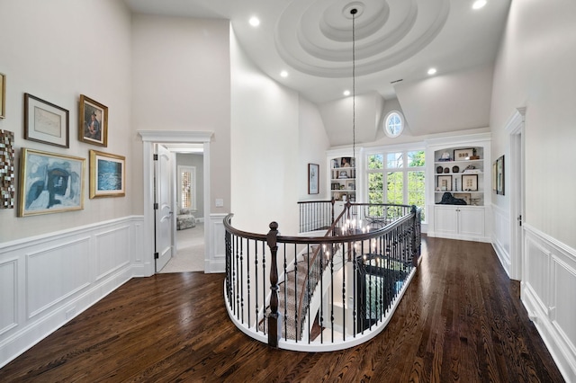 494 Greenleaf Ave, Glencoe, IL 60022 - corridor with an upstairs landing, high vaulted ceiling, a decorative wall, dark wood-style flooring, and a wainscoted wall