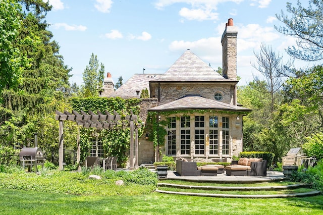 494 Greenleaf Ave, Glencoe, IL 60022 - rear view of house featuring a pergola, a high end roof, stone siding, and outdoor lounge area
