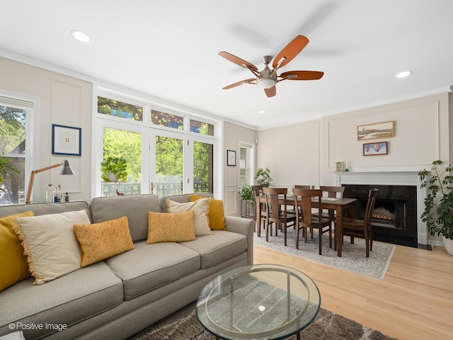 840 N Wood St Unit 2, Chicago, IL 60622 - living area with light wood-style floors, ceiling fan, a fireplace, crown molding, and a decorative wall